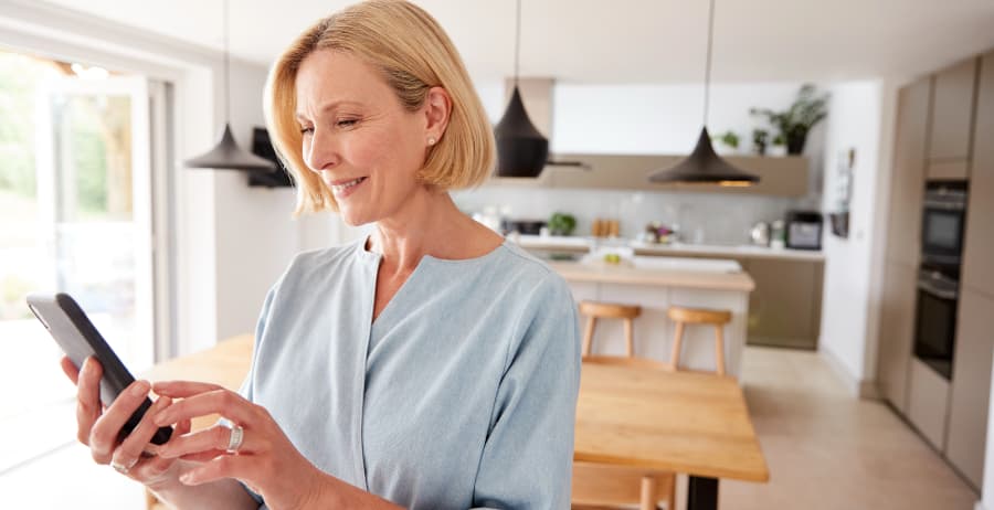Resident using a mobile device in a room filled with sunlight